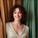 Portrait of Elara Thorne, a home textiles specialist, surrounded by luxurious fabrics